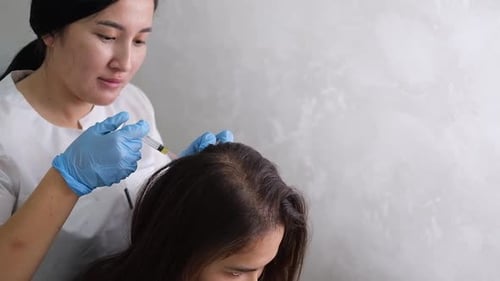 Woman getting injection in her head at clinic
