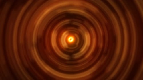 Abstract background of bright orange glowing energy magic radial circles