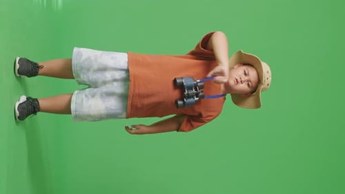 Tourist Boy Researcher Looking Through Binoculars, Showing Thumbs Down Gesture