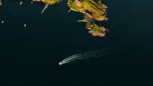 Top Down View of Motor Boat Sails Around the Coast of the Island Camera Rotates