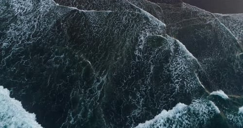 Top Down View of White Foam Waves on Sandy Beach