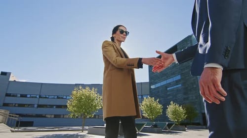 Business Handshake Between Woman and Man Outdoors