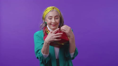 An Elegant Senior Woman Dressed in Vibrant Attire Adorned with Colorful Accessories