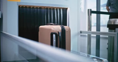 Luggage Passes Through Airport Security Scanner