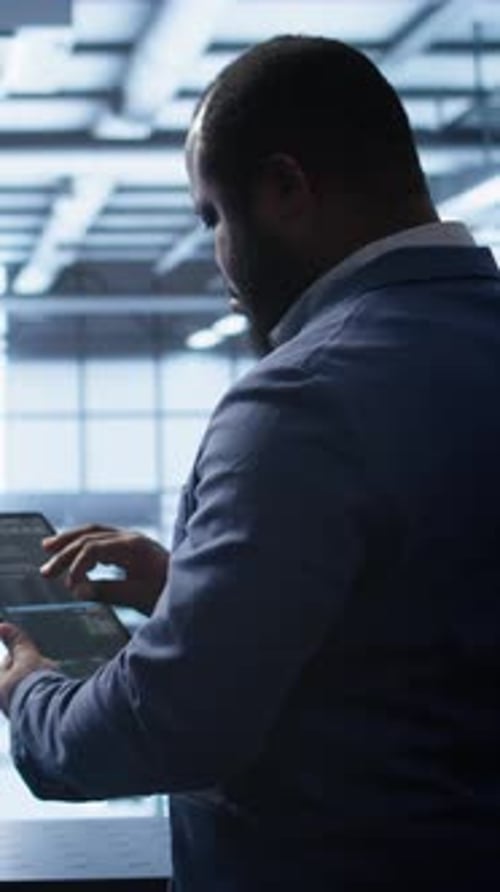 Vertical Video IT Expert in Data Center Holding Tablet Replacing Storage Mainframes Components