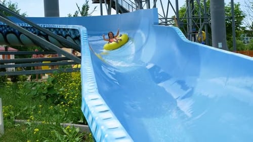 Little Girl Jumps Into an Inflatable Circle with a Pool Side Children Have Fun and Play Dives on the