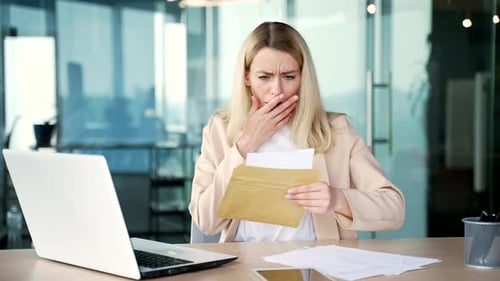 Woman Shocked by Documents in Modern Office