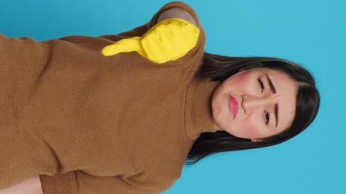 Young Adult Wiping Camera with Yellow Glove