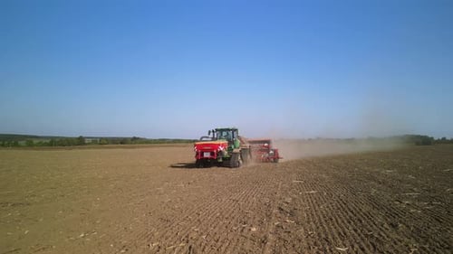 Tractor on the field seeding wheat