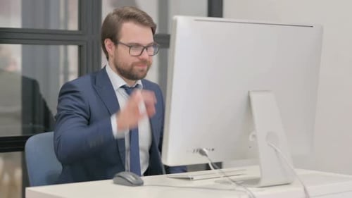 Professional Man Working and Talking at Office Computer