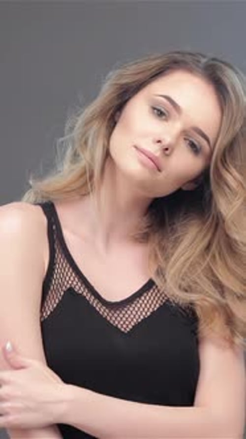 Blonde woman poses and blows a kiss