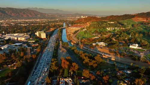 Sunset in Los Angeles, California, USA. Drone footage over the lively highway and Los Angeles River