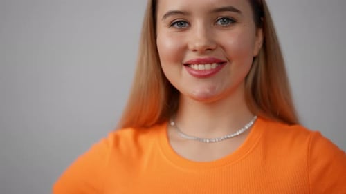 Young Woman Posing Isolated in Studio Smiling Cute Beautiful Adult Girl in Orange Tshirt with Blond