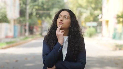Businesswoman Thinking on Urban Street