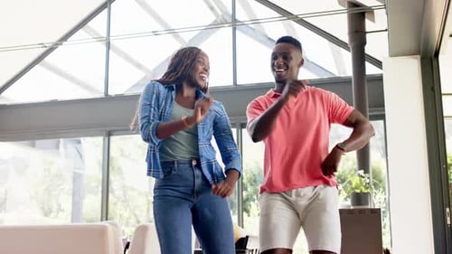 Stylish Couple Dancing and Laughing at Home