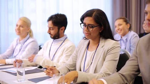 Professionals Attending Corporate Conference Taking Notes