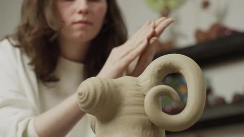 Adult Sculpting Clay Animal Indoors at Studio