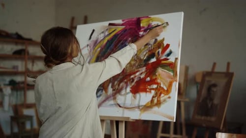 Back View of Young Woman Painter Creating Artwork Indoor. Inspired Girl Drawing