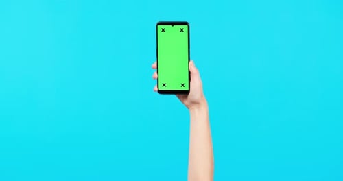 Person, hands and phone mockup with green screen for advertising against a blue studio background