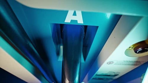 EV charging station. Man is plugging off power cord. close up. pov