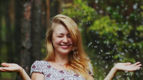 Smiling Blonde Woman with Flowers in Forest