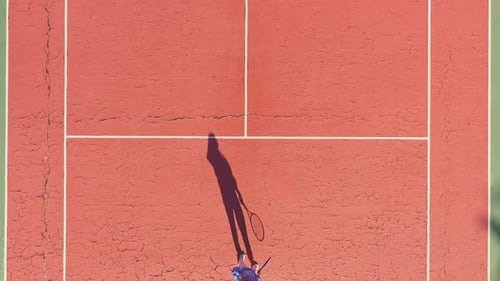 Overhead View of Woman and Shadow Playing Tennis