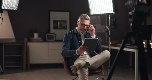 Mature Man Using Tablet in a Studio Setting