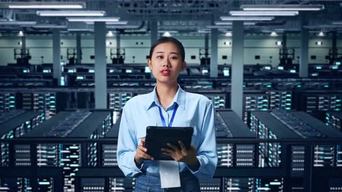 An Asian Business Woman Using Tablet An Looking Around In Data Center