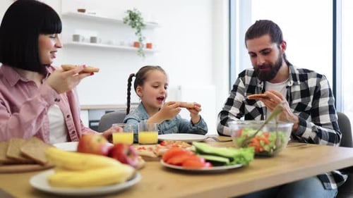 Family Enjoying Pizza Together at Home