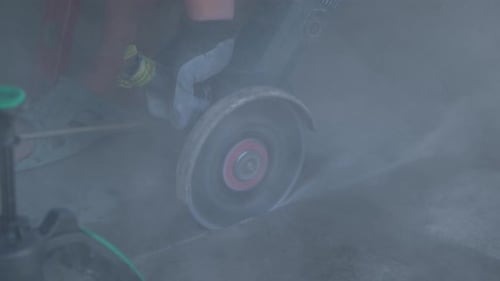 A Grinder Cuts Concrete Closeup