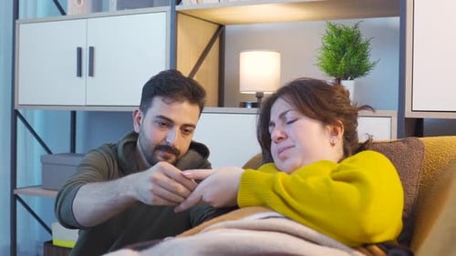Caring Man Helps Sick Woman at Home