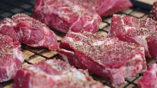 Closeup View Of Raw Beef Meat With Spices And Salt Cooking Delicious Steak In Luxury Restaurant