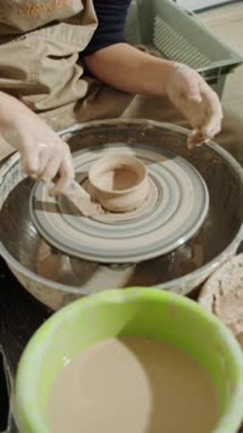 Person Shaping Clay on Pottery Wheel