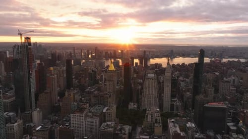 Aerial Views Showcase the Sun Rising Over the New York City Skyline Illuminating the East River and