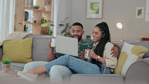 Couple Relaxing at Home with Laptop Computer