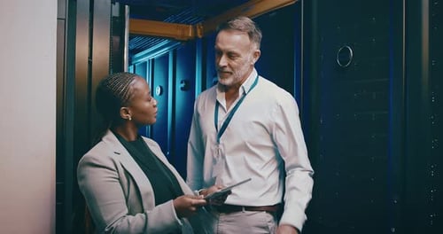 Colleagues Discuss Server Data in Modern Office