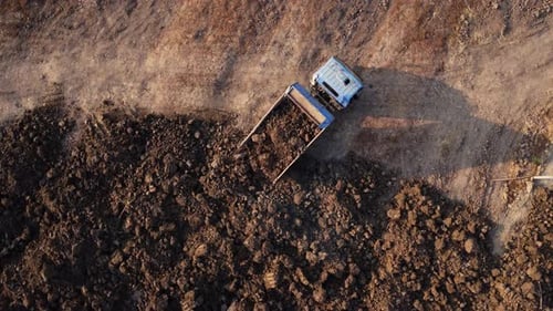 Aerial view of heavy earthmovers in construction site.