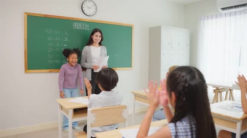 Group of student learn with teacher in classroom at elementary school.