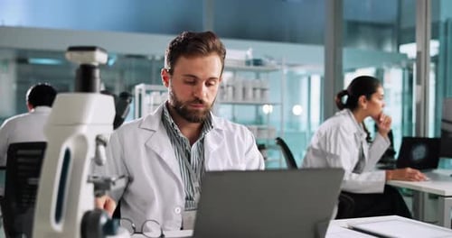 Tired Scientist Working in Modern Laboratory