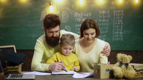 Family Doing Homework Together at Desk with School Supplies