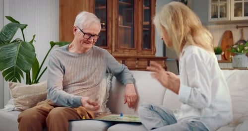 Senior Couple Playing Board Game at Home