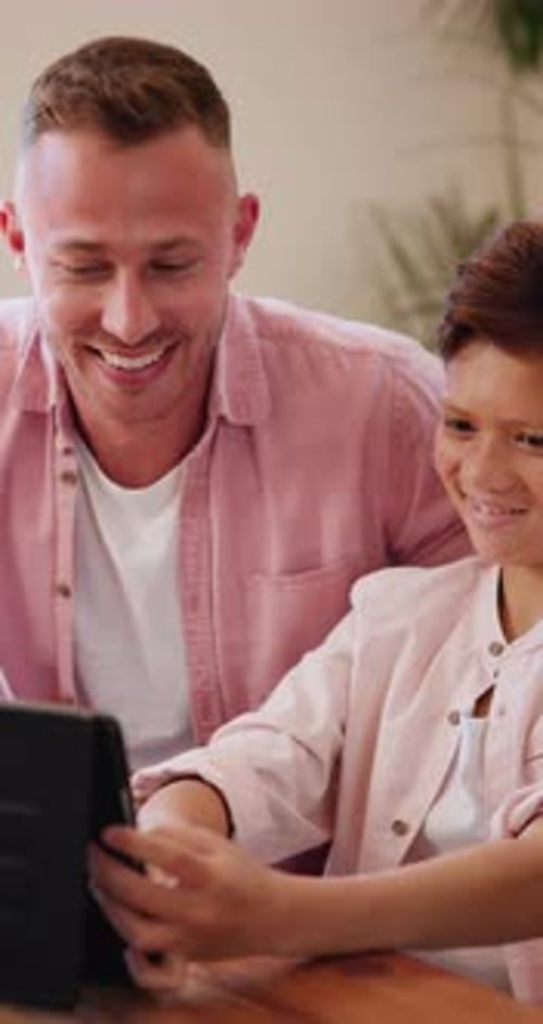 Father, boy child and tablet for games, elearning or streaming video with laughing