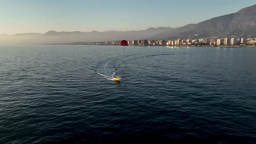 Parasailing Over the Sea at the Most Beautiful Sunset Hour