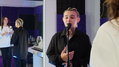 Girl with Braid Hair Sings Into Microphone in Music Studio