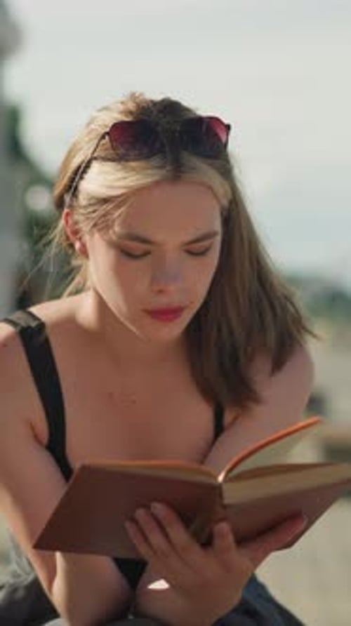 Woman Reads Book Outdoors in Vertical Format