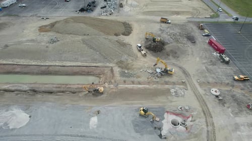 An aerial view of a busy construction site and few excavator are seen around the construction site