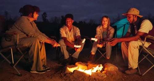 Friends, camping and smores on roast by fire with talking, travel adventure and holiday at night