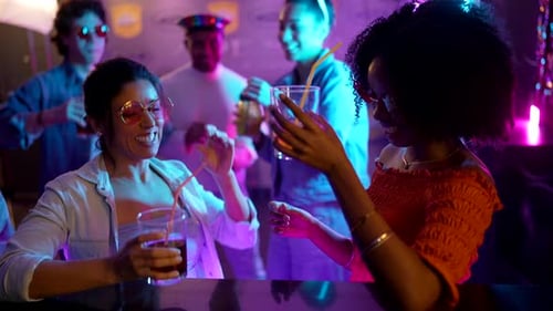 Friends Toasting Drinks at a Nightclub Event Together