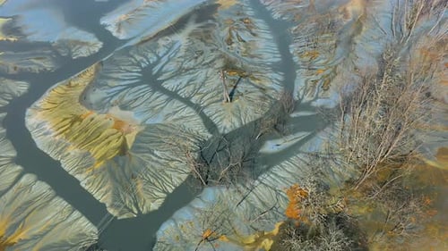 Flying over decanting lake. Colorful AMD acid mine drainage waters aerial view