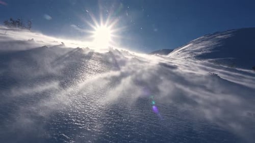 Panorama of Frozen Winter Alps Mountains with Snow Blown by Strong Wind in Windy Nature